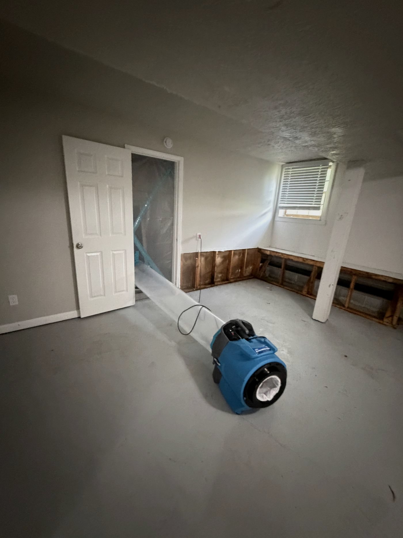 Air movers drying a room after a water loss